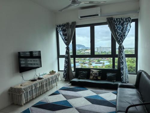 a living room with a couch and a large window at Cozy&Comfy Suite Room Perai in Perai