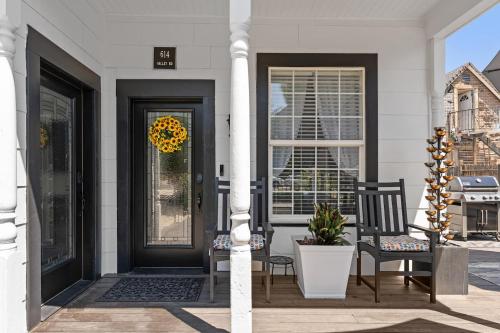 a front door of a white house with a sunflower wreath at Historic 1914 Cottage in Reno