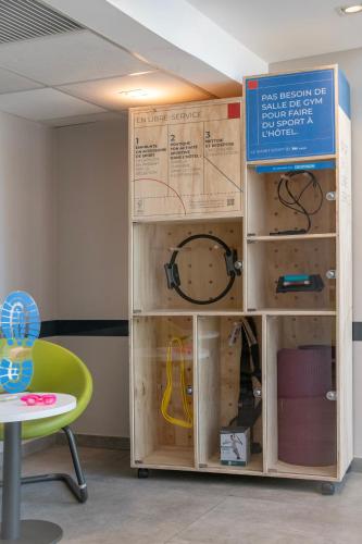 a room with boxes and a table and a chair at ibis budget Nice Californie Lenval in Nice