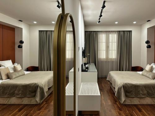 a hotel room with two beds and a mirror at HOTEL METROPOL Club House in Yerevan