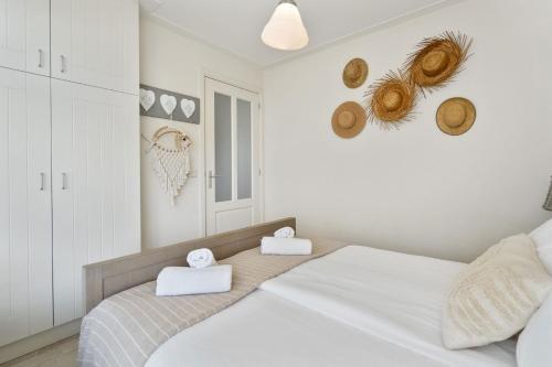 a bedroom with a bed with two towels on it at Appartement De Kokkel Free Parking in Zandvoort