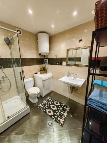a bathroom with a toilet and a shower and a sink at Studio Koper in Koper