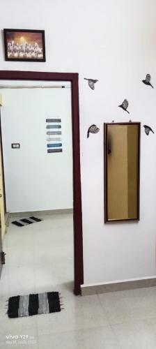 a mirror on a wall in a room at Vels Home Stay Temple View in Jāmb