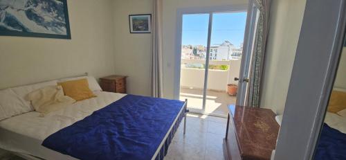 a bedroom with a bed and a view of a balcony at Centrico piso en Marbella in Marbella