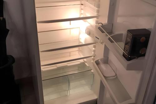 a white refrigerator with its door open with its at Appartamento In Chalet in Domène