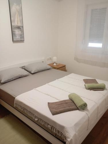 a bedroom with a bed with two towels on it at Charming sparcle in Dalmatia in Zadar