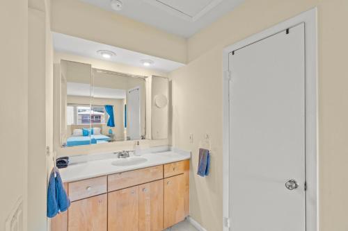 a bathroom with a sink and a mirror at Steps To Beach! 4 Condos In 1- Perfect For Groups in West Palm Beach