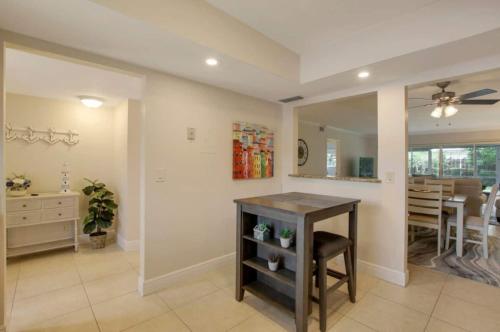 a living room with a table and a dining room at Steps To Beach! 4 Condos In 1- Perfect For Groups in West Palm Beach