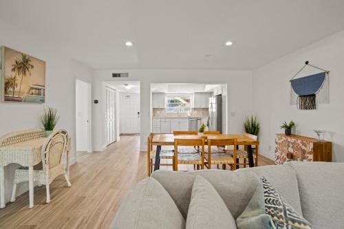 a living room with a couch and a table at Steps To Beach! 4 Condos In 1- Perfect For Groups in West Palm Beach