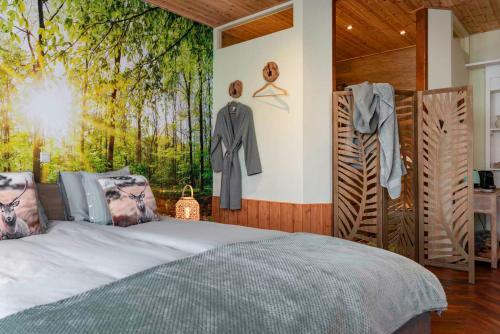 a bedroom with a bed and clothes hanging on a wall at B&B 't Gemeentehuis in Biervliet