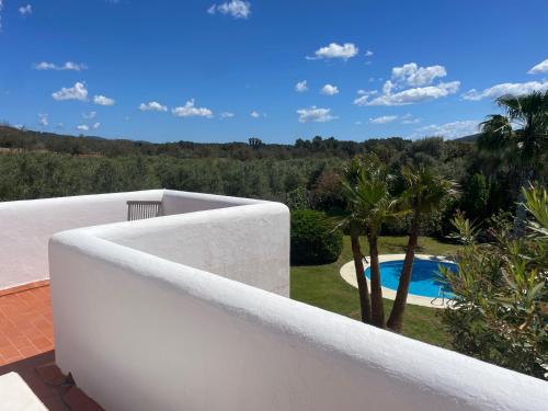 a white fence next to a swimming pool at Authentic Villa with amazing pool in Santa Gertrudis de Fruitera