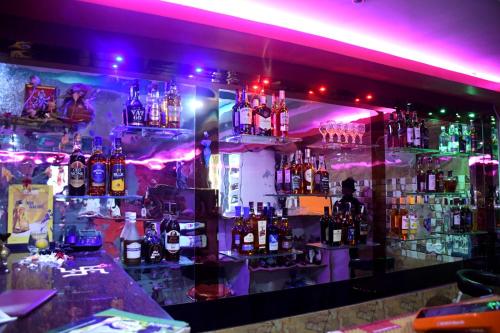 a bar filled with lots of bottles of alcohol at Hotel New Jasmine in Cuttack