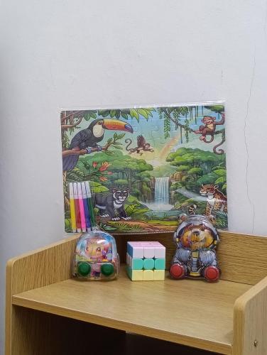 a shelf with toys sitting on top of it at Air Puteri Rest House in Mersing