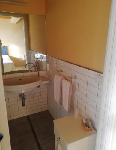 a bathroom with a sink and a mirror at Agriturismo Cascina Palazzo in Roddi