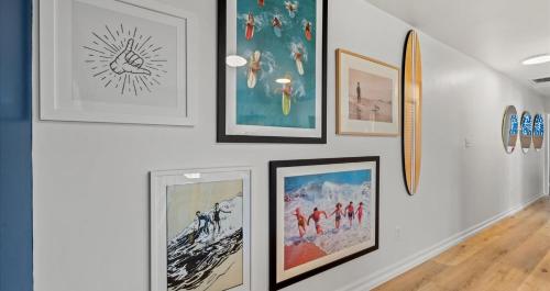 a wall with paintings and pictures on it at Cabana Beach 4 Bright 2BR Condo Steps from the Sand in Myrtle Beach