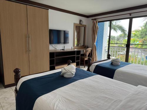 Ένα ή περισσότερα κρεβάτια σε δωμάτιο στο Blue Garden Resort Pattaya