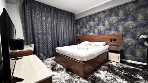 Katil atau katil-katil dalam bilik di Hotel City rooms Bogenbay