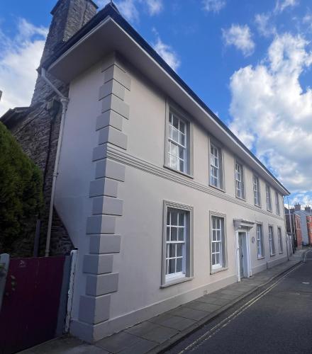a white building with windows on a street at Cantre Selyf in Brecon