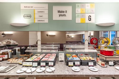 a bakery with a counter with food on display at Garner Hotel Aschaffenburg Post by IHG in Aschaffenburg