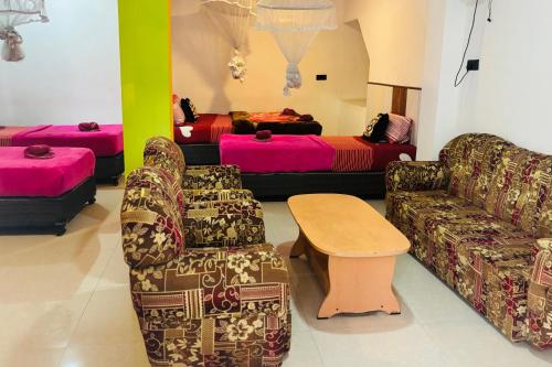 a living room with two couches and a table at Grand adamspeak hotel & restaurant in Adams Peak
