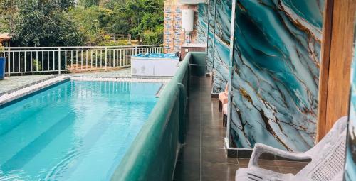 a swimming pool with a slide in a house at Grand adamspeak hotel & restaurant in Adams Peak