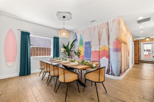 a dining room with a long table and chairs at Heated Cocktail Pool, Putt Putt, Bowling, BBQ, Nintendo, Pet Friendly, Ping Pong in St. Augustine