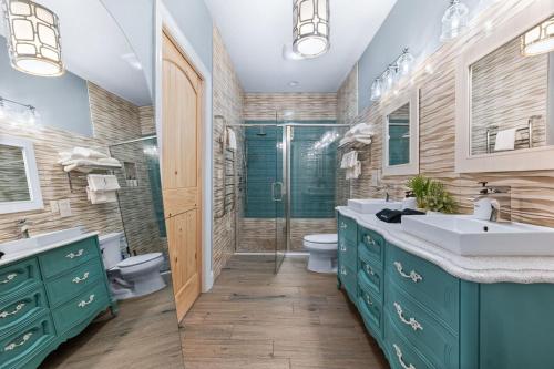 a bathroom with green cabinets and a shower and a sink at Heated Cocktail Pool, Putt Putt, Bowling, BBQ, Nintendo, Pet Friendly, Ping Pong in Saint Augustine