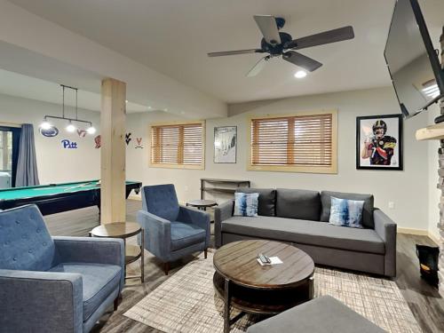 a living room with a couch and a pool table at Hearthstone in McHenry