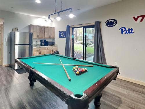 a kitchen with a pool table in a room at Hearthstone in McHenry