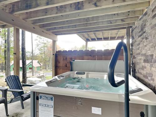 a hot tub in a patio with a table and chairs at Hearthstone in McHenry