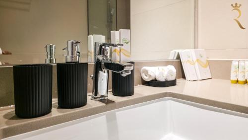 a kitchen counter with two faucets on a counter top at 1BR Cozy Yas Island with 10 Min to Grand Prix in Abu Dhabi