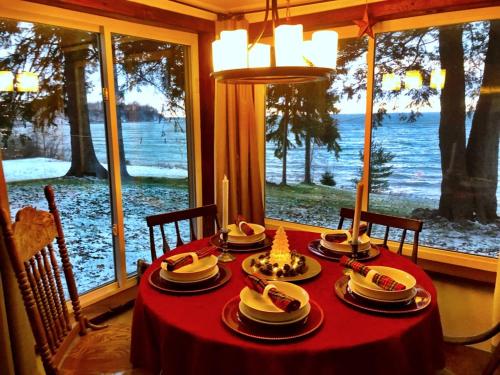 a table with a red table cloth with food on it at Lakefront Pine Cottage Hot Tub & Fire Pit in Sodus