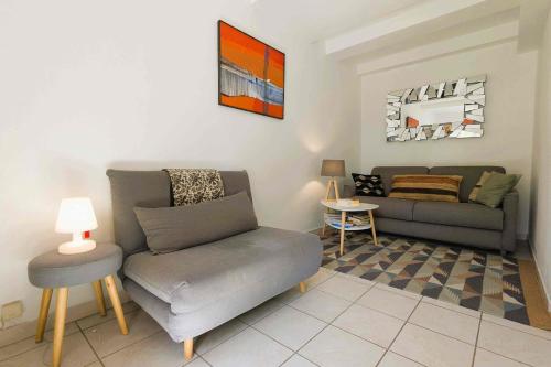 a living room with a couch and a chair at Charming studio for 2 in Pradet in Le Pradet