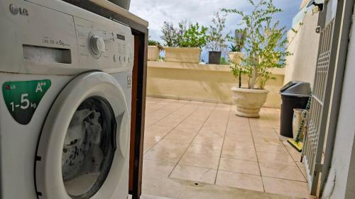 a washing machine sitting on the side of a house at Appartement a Kantaoui in Port El Kantaoui