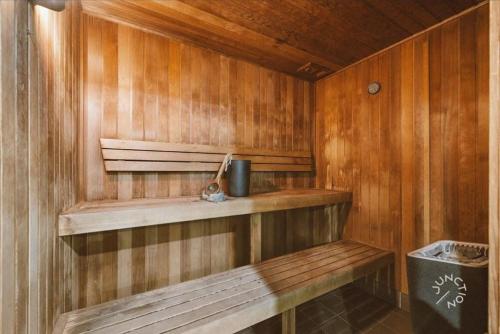 a wooden sauna with a bench and a trash can at Brisbane Central CBD convivence! in Brisbane