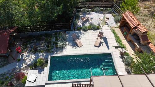 an overhead view of a swimming pool with patio furniture at Beloviski raj 