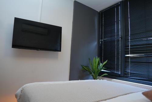 a bedroom with a flat screen tv on the wall at Vico hotel in Istanbul