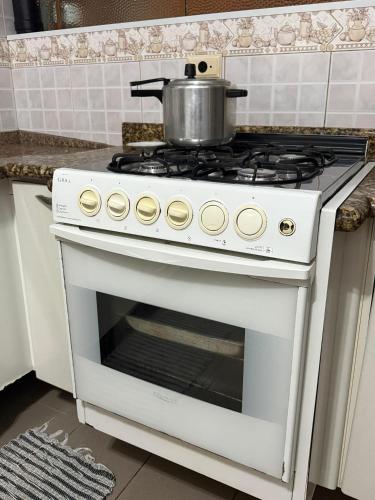 a white stove with a pot on top of it at Alpha Hostel in Barueri