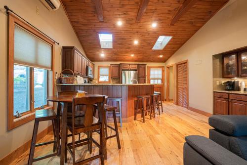 a kitchen with wooden cabinets and a table and chairs at King Bed, Putt-Putt w/ Hot Tub, & Other Games in Banner Elk