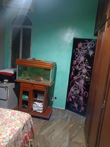 a room with a fish tank on a wall at Casa Paraense in Belém