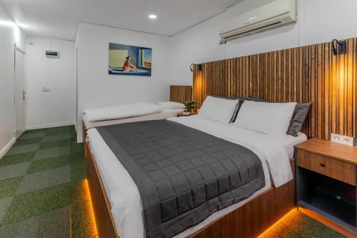 a bedroom with a large bed with a wooden headboard at Vico hotel in Istanbul