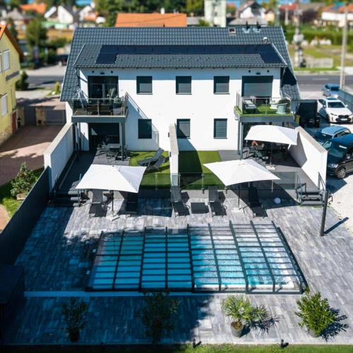 an aerial view of a building with a swimming pool at Bala-Home Apartments & Pool in Balatonboglár