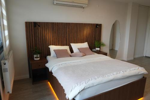 a bedroom with a large bed with white sheets and pink pillows at Vico hotel in Istanbul