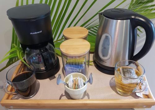 a tray with a coffee maker and other items on it at Baliyana Lodge in San José Pinilla