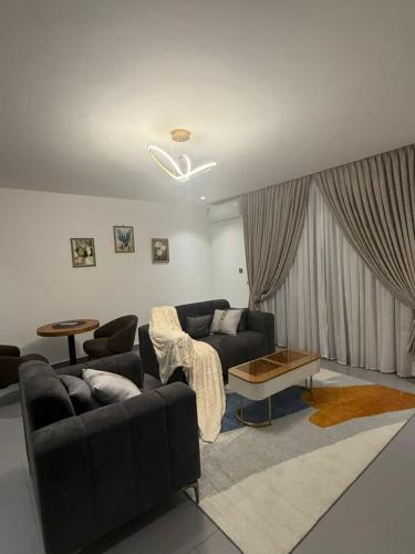 a living room with a couch and a table at 1bed with pool and restaurant apartment in Accra
