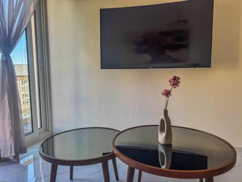 a glass table with a vase with a flower on it at The Spot in Xanthi