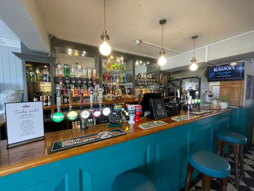 a bar with a lot of bottles of alcohol at The Sydney Arms in Dorchester
