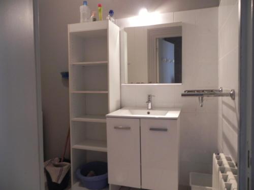 a white bathroom with a sink and a mirror at VILLA LOZELOUX n 2 in Le Mont-Dore