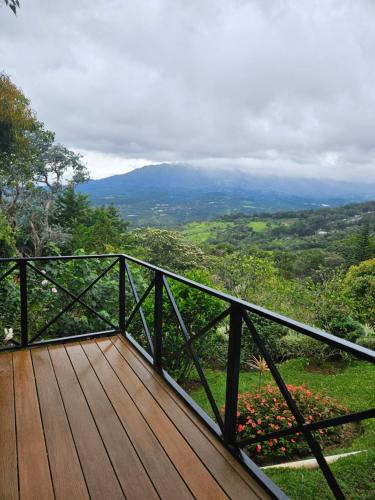 a wooden deck with a view of a valley at Cabañas El Parador in Boquete