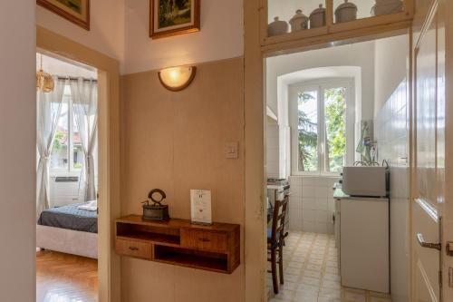 a room with a bedroom and a kitchen with a refrigerator at Vista&Capriccio in Trieste